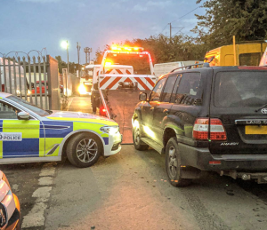 toyota_land_cruiser_recovered_on_the_back_of_a_transporter_with_police_car_present