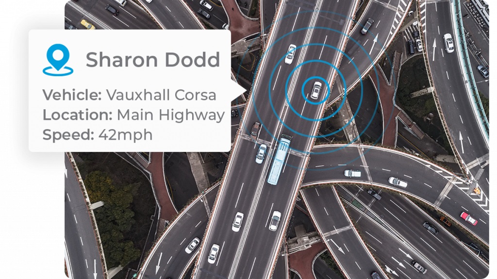 vehicle_location_tracking_car_driving_over_highway_intersection_dual_carriageway_in_moderate_traffic