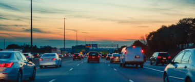 vehicles_driving_down_a_highway_in_the_early_evening