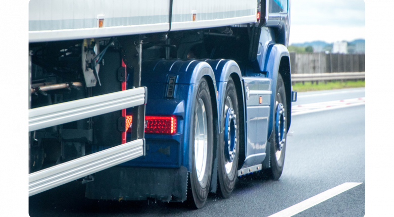 hgv_driving_on_a_road_view_from_the_rear_of_right_side_wheels_and_cab