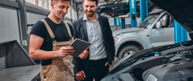 customer_listening_to_his_mechanic_at_the_repair_garage_selective