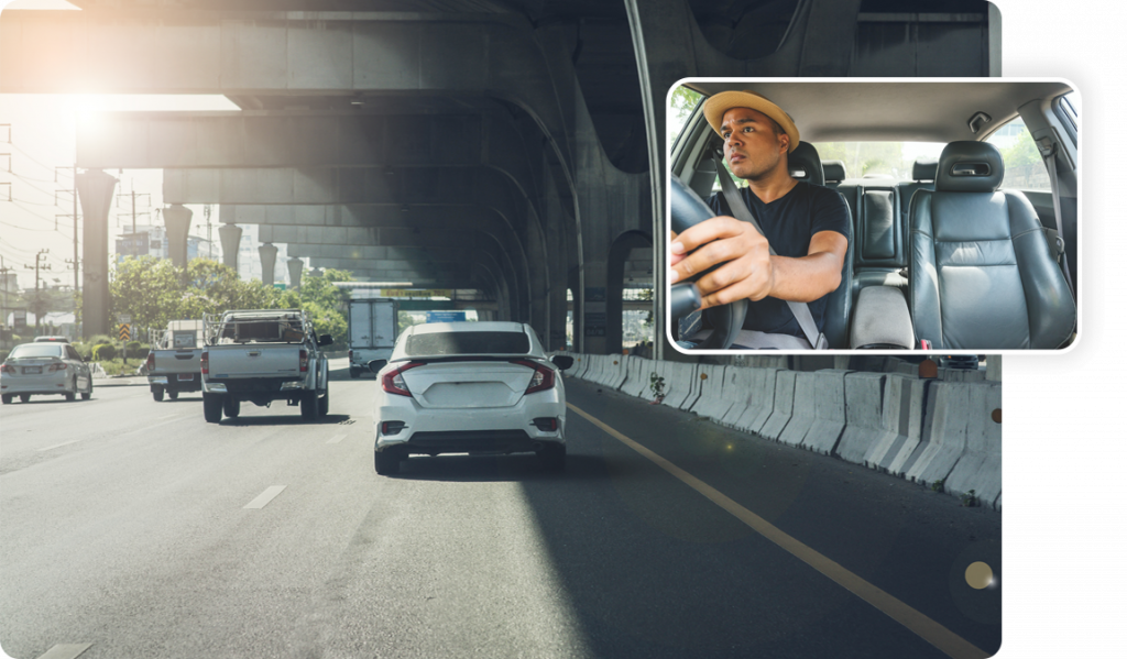 dual_facing_dashcam_showing_busy_road_with_vehicles_and_driver_concentrating