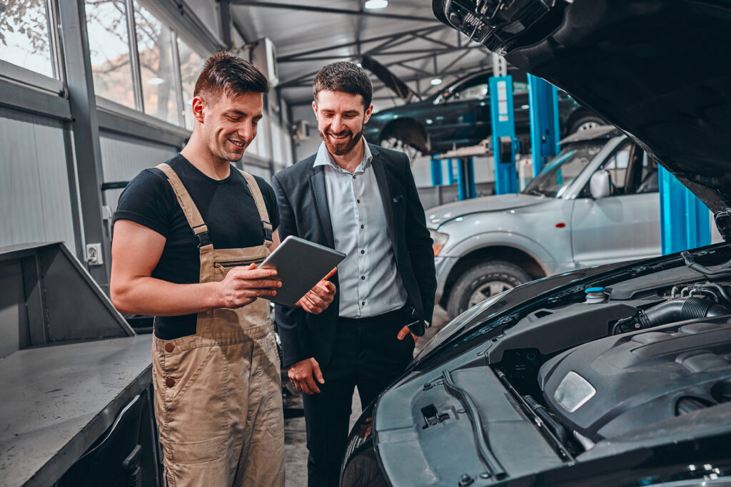 customer_listening_to_his_mechanic_at_the_repair_garage_selective