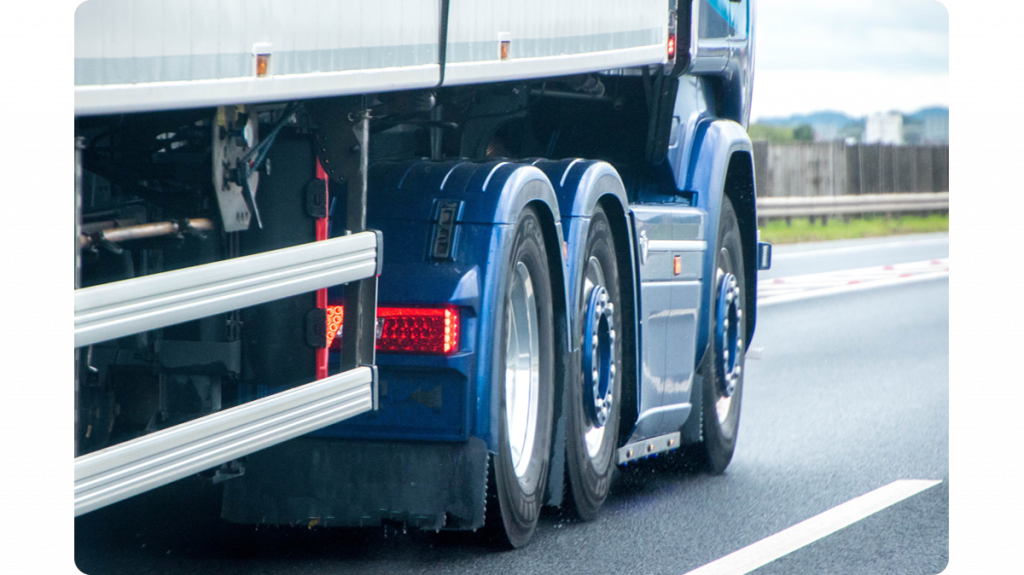 hgv_driving_on_a_road_view_from_the_rear_of_right_side_wheels_and_cab