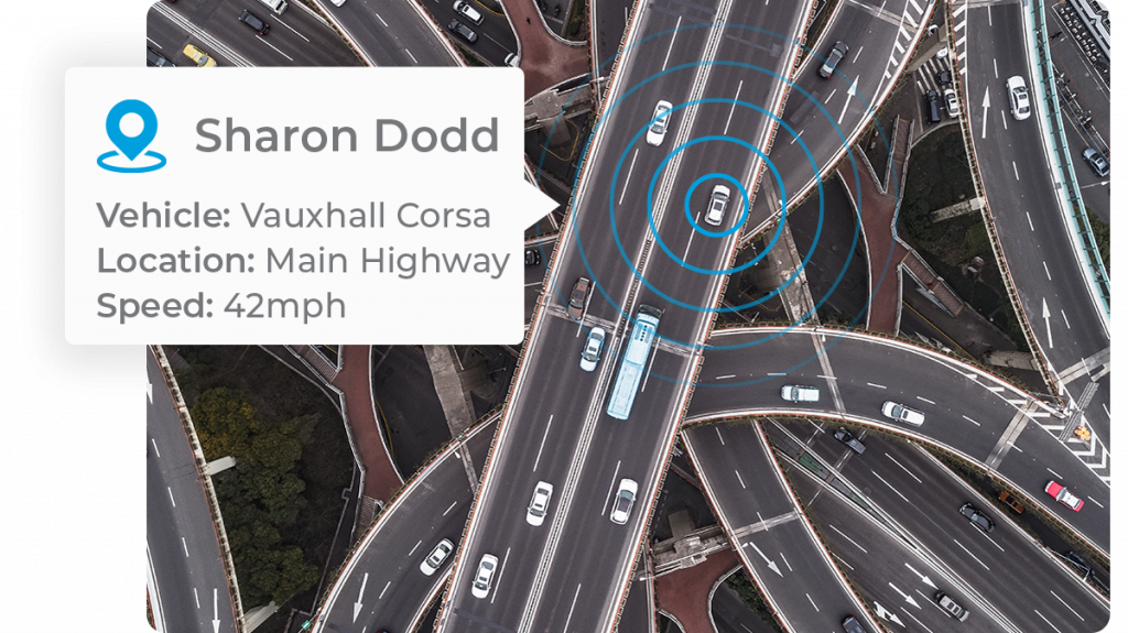 vehicle_location_tracking_car_driving_over_highway_intersection_dual_carriageway_in_moderate_traffic