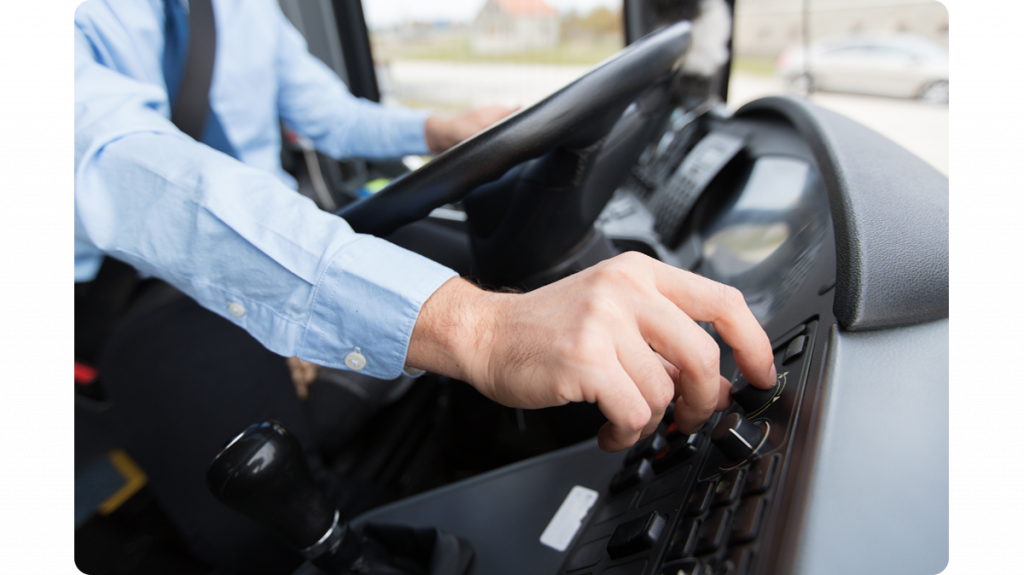 bus_driver_sitting_in_his_cab_using_dials_on_the_dashboard